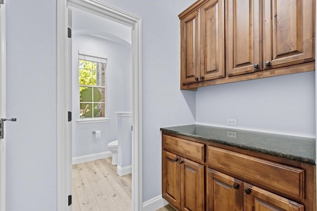 bathroom with hardwood / wood-style floors and toilet