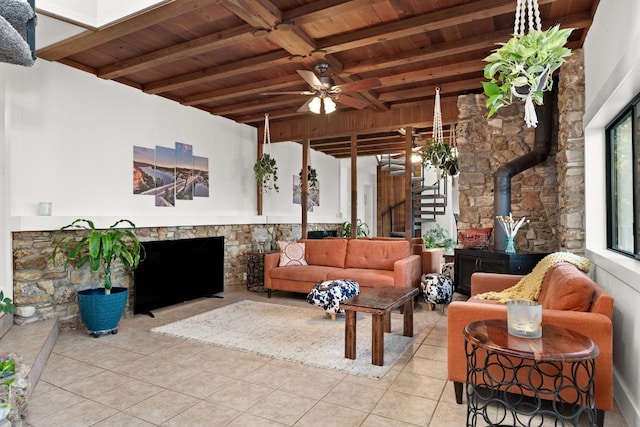 interior space with beamed ceiling, light tile patterned floors, ceiling fan, and wooden ceiling