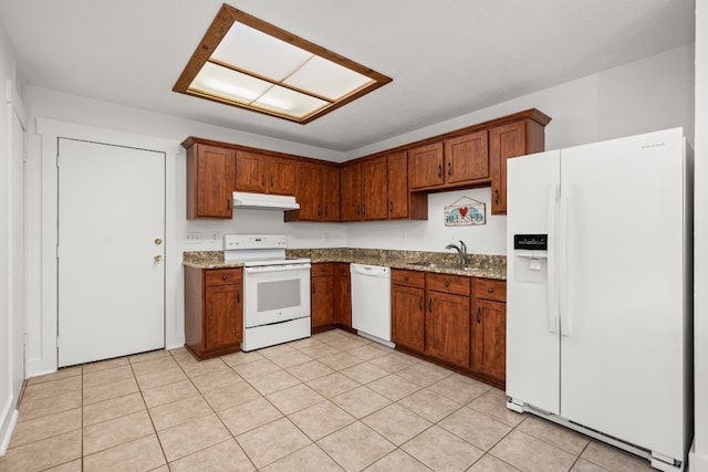 kitchen with light stone counters, sink, light tile patterned floors, and white appliances