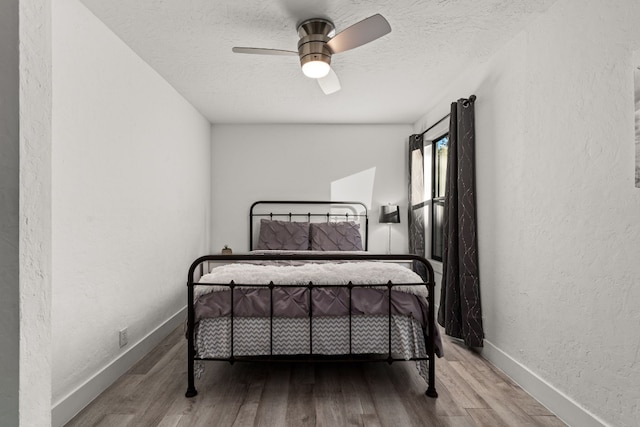 bedroom featuring hardwood / wood-style floors and ceiling fan