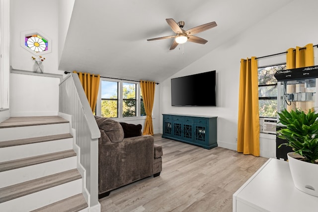 living room with vaulted ceiling, light hardwood / wood-style flooring, and ceiling fan