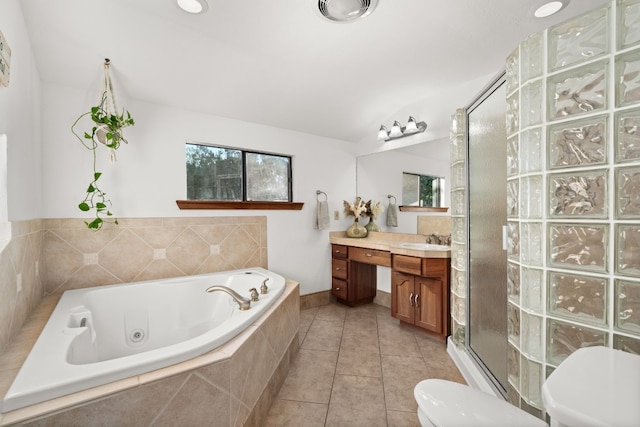 full bathroom featuring toilet, tile patterned flooring, vanity, and shower with separate bathtub