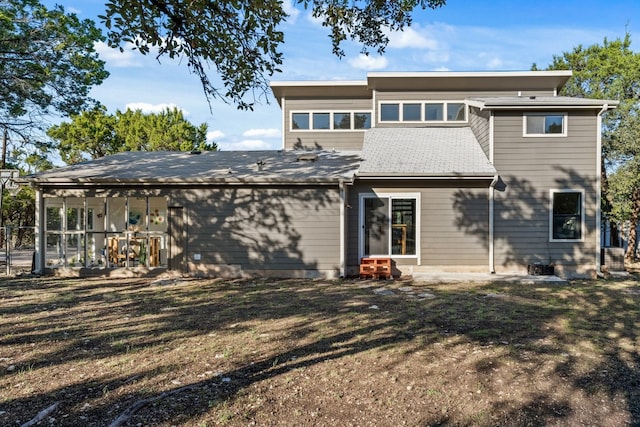 back of property featuring a lawn