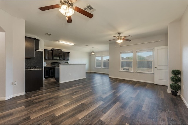 unfurnished living room featuring ceiling fan and dark wood-type flooring