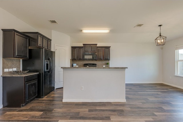 kitchen with decorative backsplash, dark brown cabinets, black appliances, pendant lighting, and dark hardwood / wood-style floors