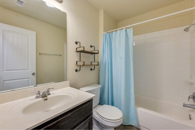 full bathroom with vanity, toilet, and shower / tub combo