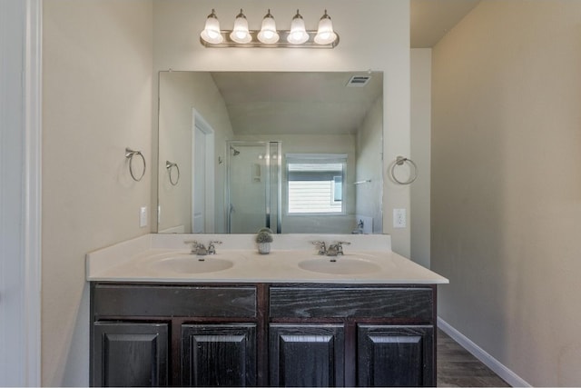 bathroom featuring wood-type flooring, vanity, and walk in shower