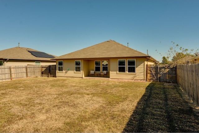 back of house featuring a yard