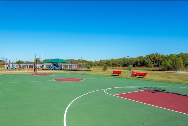 view of basketball court with a playground and a lawn