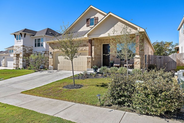 view of front of property with a front yard and a garage