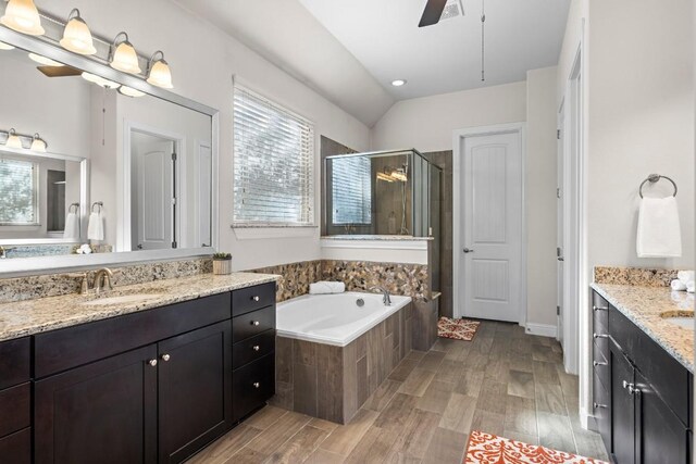 bathroom with vanity, separate shower and tub, ceiling fan, wood-type flooring, and lofted ceiling