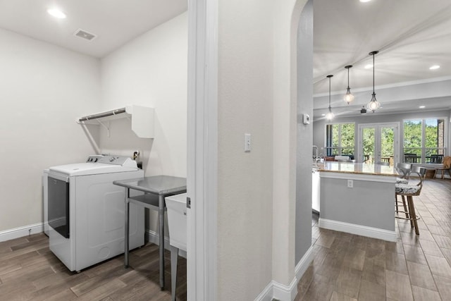 laundry area featuring washer / clothes dryer, crown molding, and dark hardwood / wood-style floors