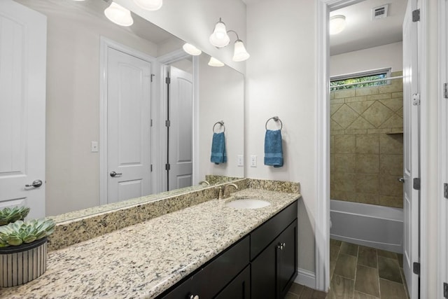 full bathroom featuring vanity, toilet, and tiled shower / bath combo