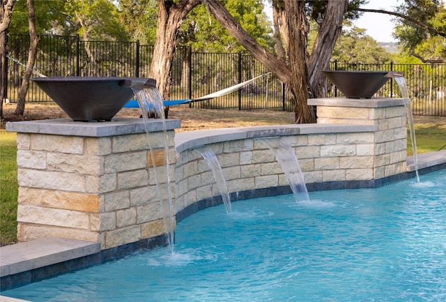 view of swimming pool with pool water feature