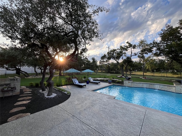 view of pool featuring a lawn, pool water feature, and a patio