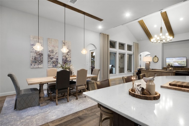 dining area featuring beamed ceiling, dark hardwood / wood-style floors, high vaulted ceiling, and a chandelier