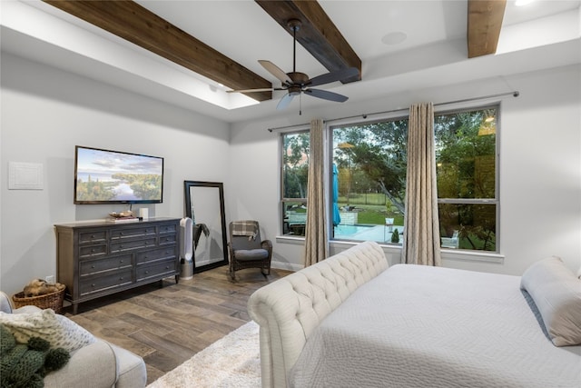 bedroom featuring beamed ceiling, ceiling fan, and dark hardwood / wood-style floors