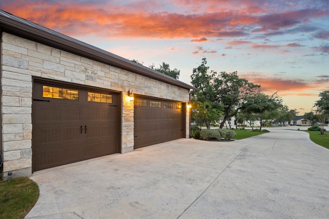 view of garage at dusk