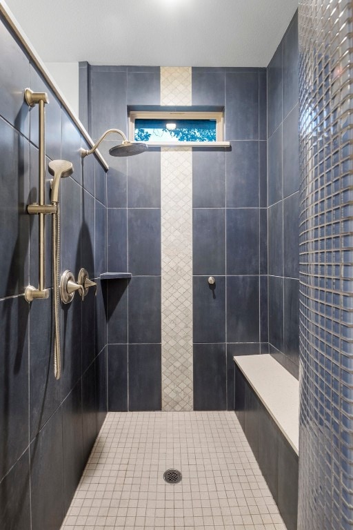 bathroom with tiled shower