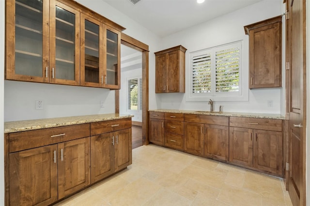 kitchen with light stone counters and sink