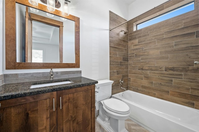 full bathroom featuring vanity, toilet, tiled shower / bath, and a wealth of natural light