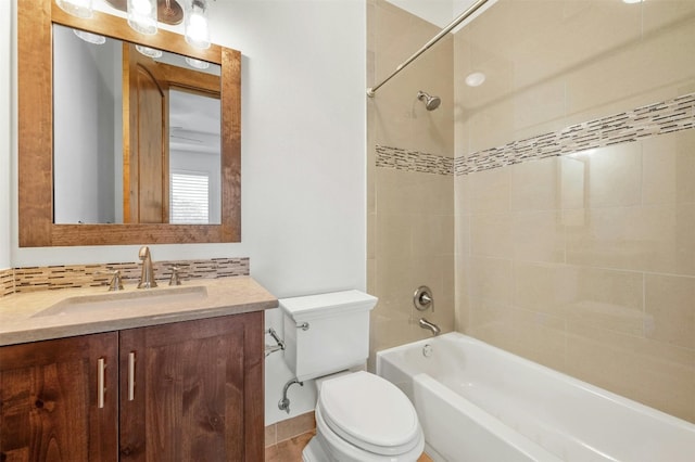 full bathroom with vanity, toilet, and tiled shower / bath