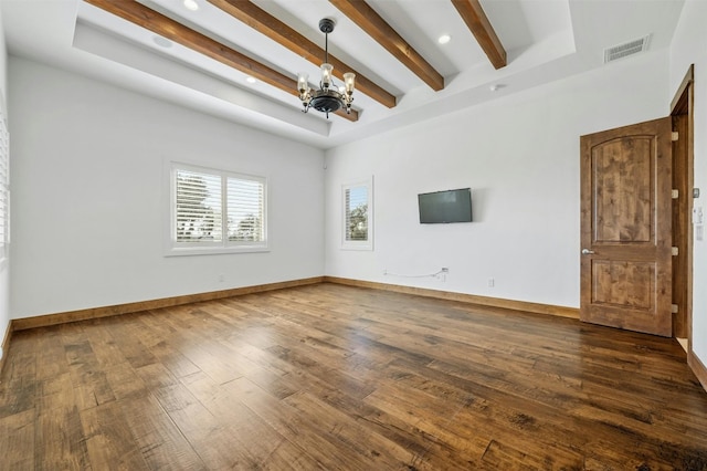 empty room with beam ceiling, dark hardwood / wood-style flooring, and a chandelier