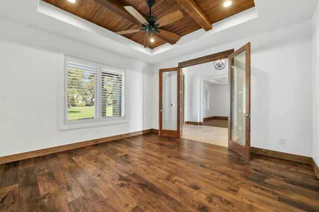 empty room with french doors, hardwood / wood-style flooring, ceiling fan, and wood ceiling