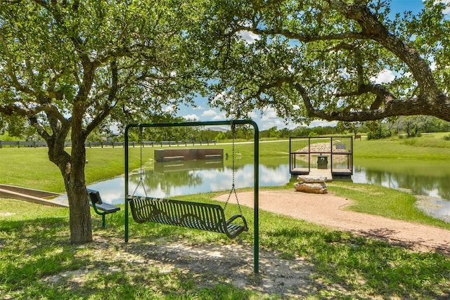 view of home's community with a water view and a yard