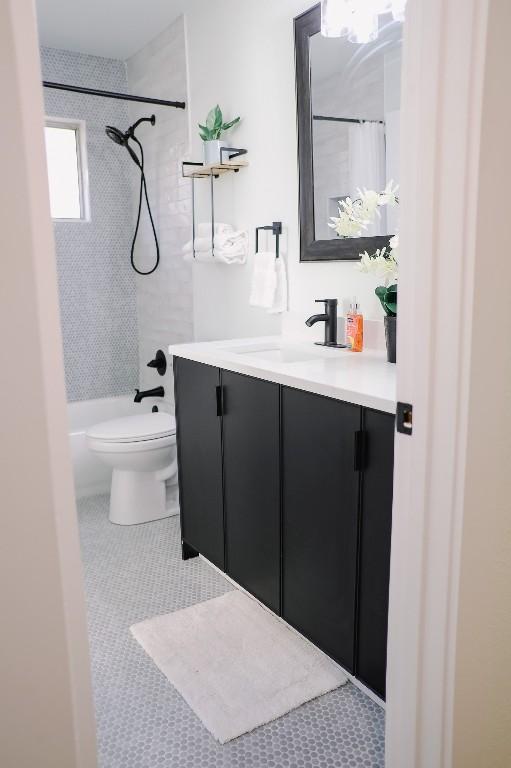 8706 Brookfield Dr, Austin, TX 78758 - bathroom featuring vanity, tile patterned floors, and shower / tub combo