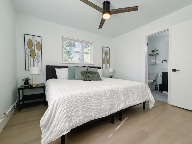 bedroom featuring ensuite bath, ceiling fan, and light hardwood / wood-style flooring