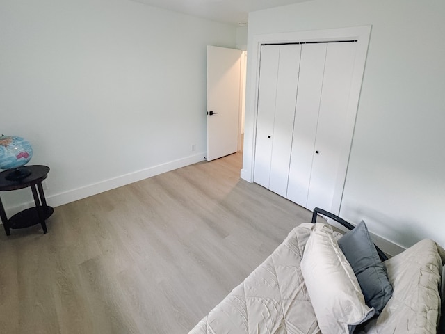 bedroom featuring light wood-type flooring and a closet