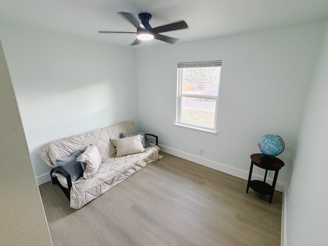 living area featuring ceiling fan and light hardwood / wood-style flooring