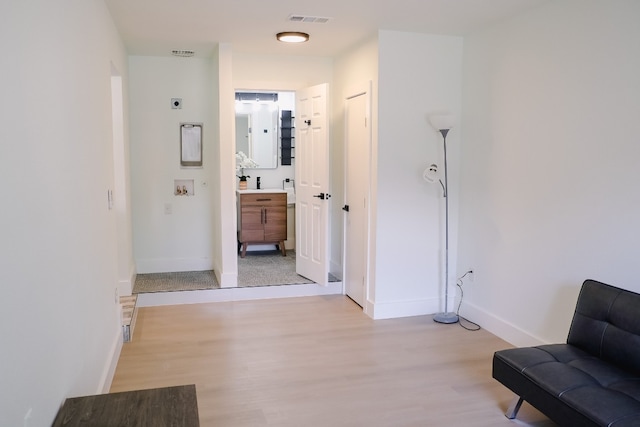 hallway with light hardwood / wood-style floors