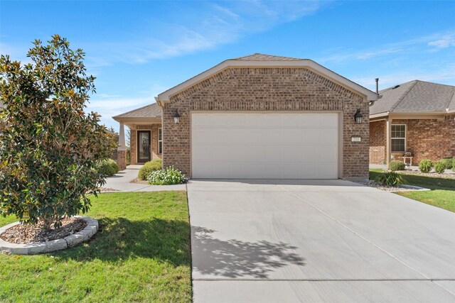 view of front of home with a garage and a front yard