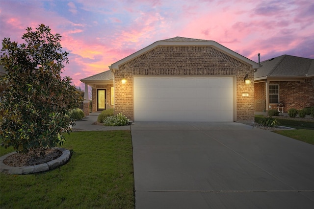 view of front of home with a lawn and a garage