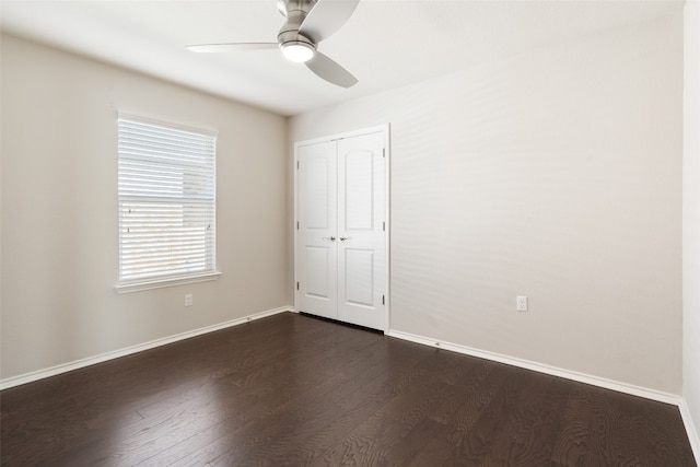 unfurnished bedroom featuring ceiling fan, a closet, and dark hardwood / wood-style floors