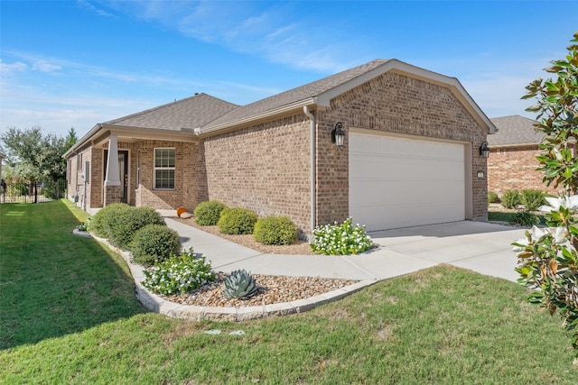 view of front of house featuring a garage and a front lawn