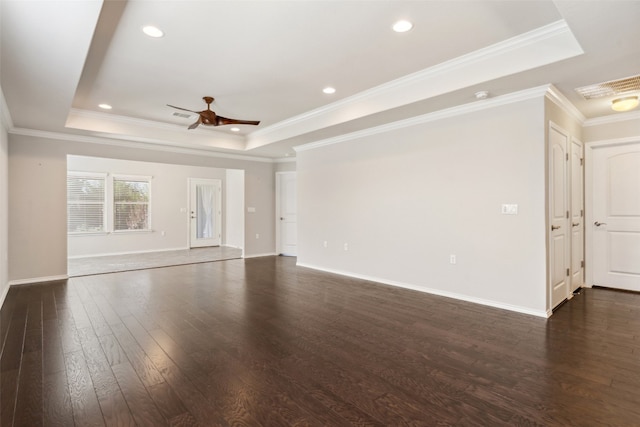 unfurnished living room featuring dark hardwood / wood-style flooring, a raised ceiling, ceiling fan, and crown molding