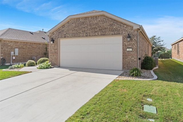 view of front of property with a front yard and a garage