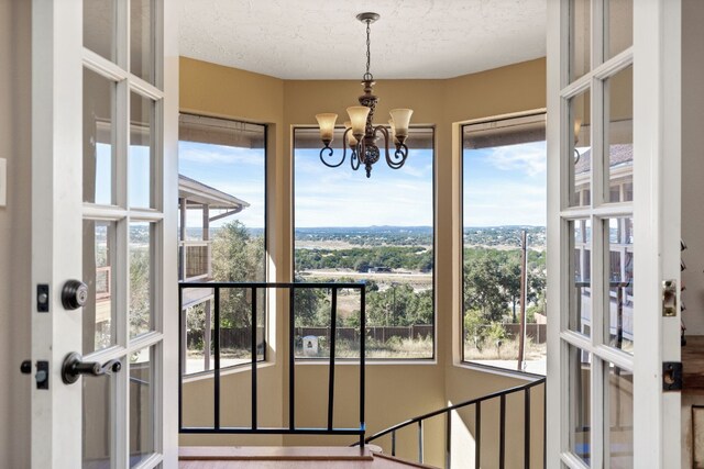 sunroom / solarium with a notable chandelier