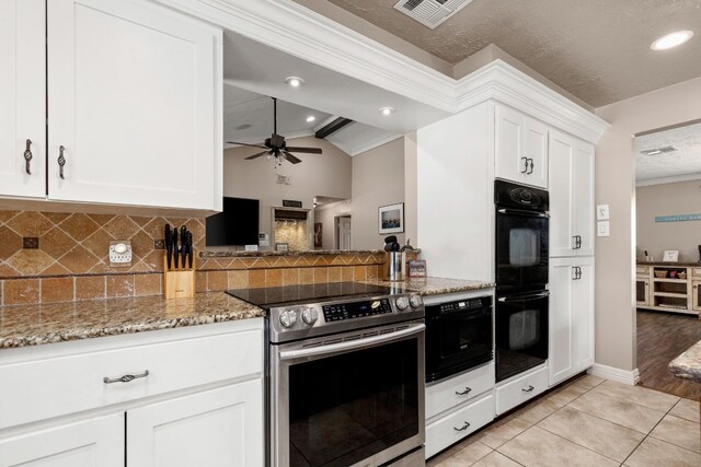 kitchen featuring light wood-type flooring, vaulted ceiling, double oven, electric range, and white cabinetry