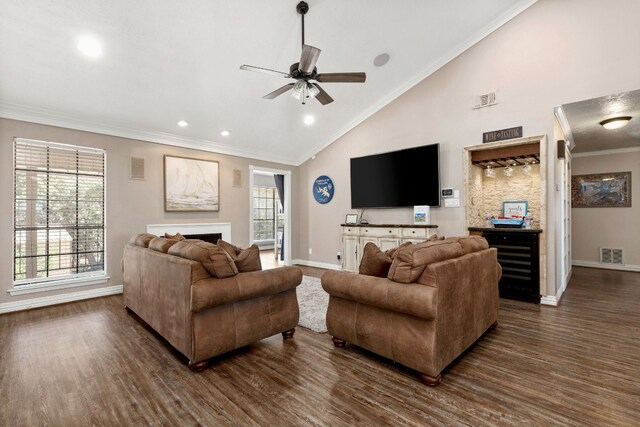 living room with ceiling fan, high vaulted ceiling, dark wood-type flooring, and ornamental molding