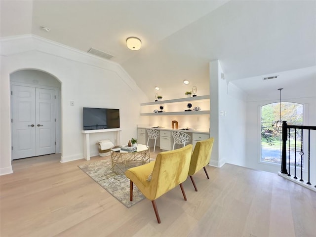 living room with lofted ceiling and light wood-type flooring