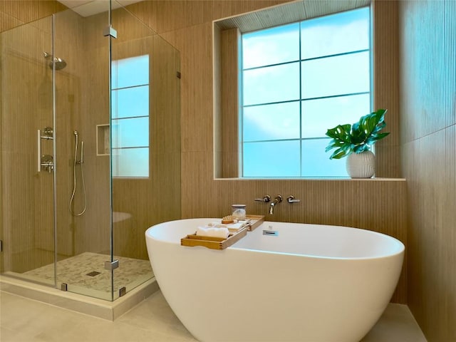 bathroom with tile patterned floors and independent shower and bath