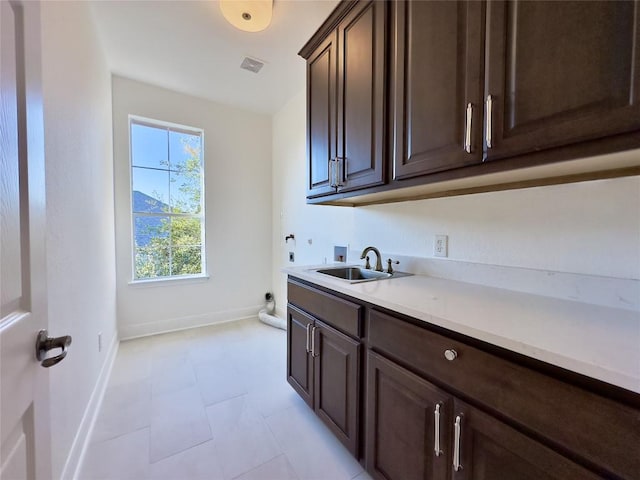 washroom with washer hookup, electric dryer hookup, cabinets, and sink