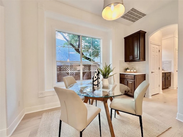 dining space with light hardwood / wood-style floors