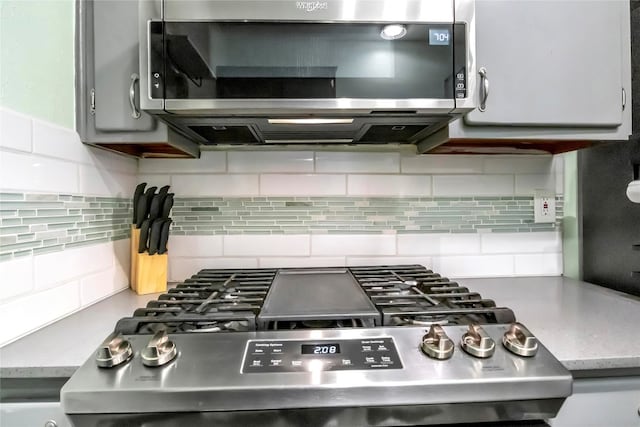 kitchen with decorative backsplash and stainless steel appliances