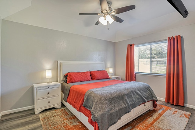 bedroom featuring vaulted ceiling with beams, dark hardwood / wood-style flooring, and ceiling fan