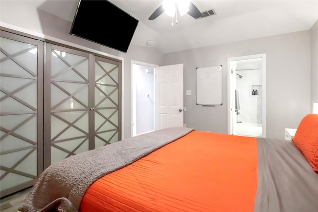 bedroom with ensuite bath, ceiling fan, and lofted ceiling